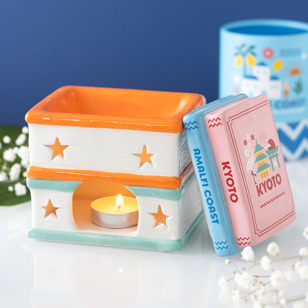 quemador de wax melts con forma de libros de viaje abierto